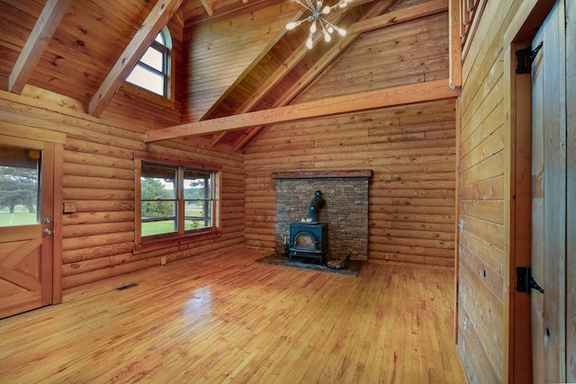 1794 Mosley Ferry Rd, Chapmansboro, TN 37035 - unfurnished living room with a wood stove, hardwood / wood-style floors, a chandelier, high vaulted ceiling, and wood ceiling with exposed beams