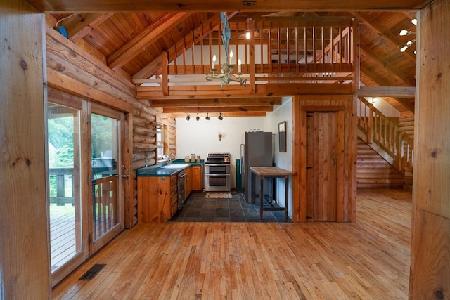 1794 Mosley Ferry Rd, Chapmansboro, TN 37035 - kitchen featuring stainless steel appliances, a sink, rustic walls, dark wood-type flooring, and brown cabinets