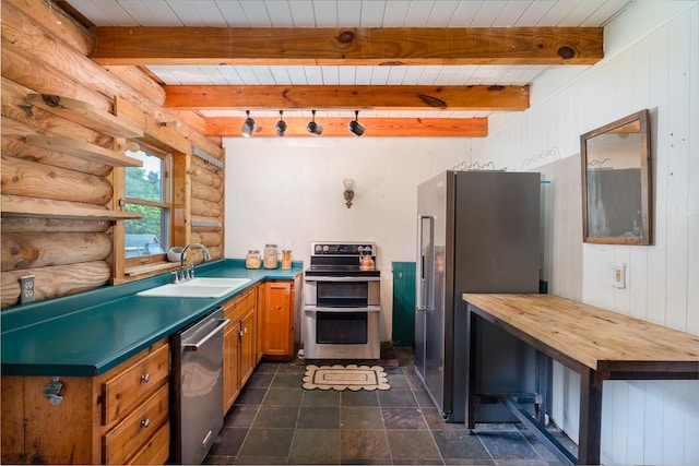 1794 Mosley Ferry Rd, Chapmansboro, TN 37035 - kitchen featuring appliances with stainless steel finishes, a sink, brown cabinetry, wood ceiling with exposed beams, and rustic walls