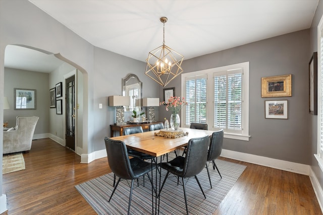2209 Natchez Trce, Nashville, TN 37212 - dining room with arched walkways, a chandelier, baseboards, and dark wood-style floors