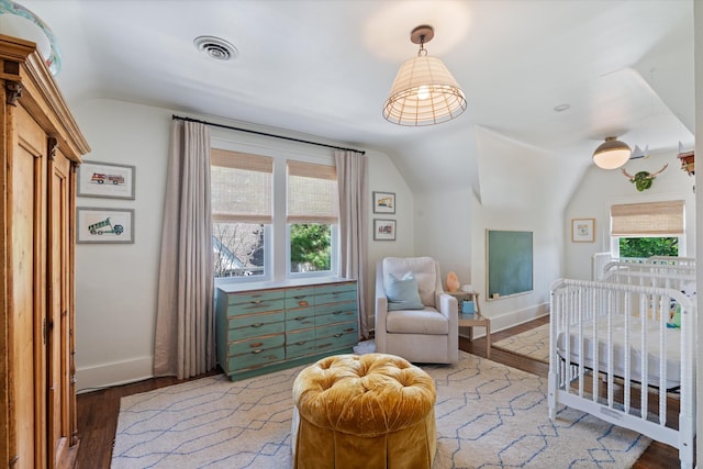 2209 Natchez Trce, Nashville, TN 37212 - bedroom with lofted ceiling, wood finished floors, multiple windows, baseboards, and a nursery area