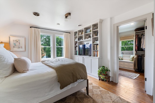 2209 Natchez Trce, Nashville, TN 37212 - bedroom featuring light wood-type flooring, multiple windows, lofted ceiling, a spacious closet, and a closet