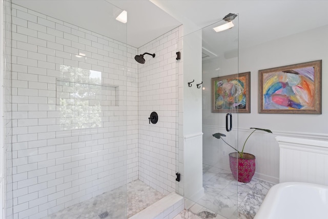 2209 Natchez Trce, Nashville, TN 37212 - bathroom with marble finish floors, a shower stall, a soaking tub, and a wainscoted wall