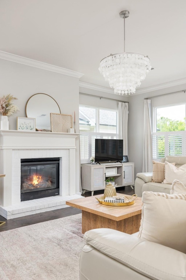 2060 Bushnell Farm Dr, Franklin, TN 37064 - living room featuring ornamental molding, wood finished floors, a glass covered fireplace, and a chandelier