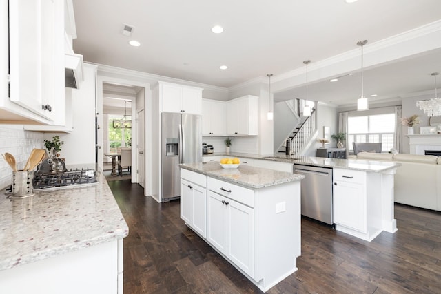 2060 Bushnell Farm Dr, Franklin, TN 37064 - kitchen with appliances with stainless steel finishes, a peninsula, a kitchen island, recessed lighting, and ornamental molding
