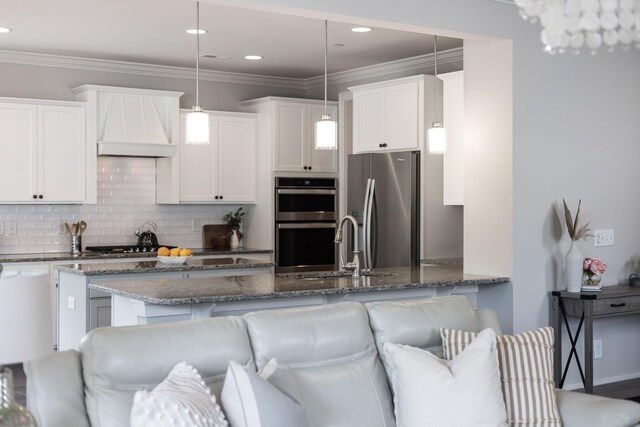 2060 Bushnell Farm Dr, Franklin, TN 37064 - kitchen with appliances with stainless steel finishes, dark stone counters, white cabinets, pendant lighting, and tasteful backsplash