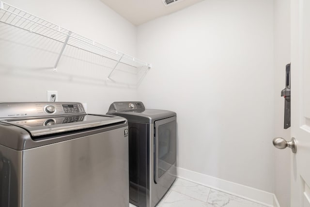 2060 Bushnell Farm Dr, Franklin, TN 37064 - laundry room with separate washer and dryer, baseboards, and light marble finish flooring