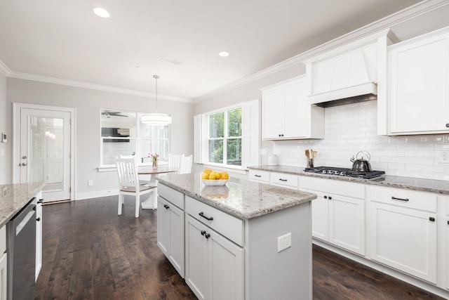 2060 Bushnell Farm Dr, Franklin, TN 37064 - kitchen with stainless steel gas stovetop, ornamental molding, tasteful backsplash, white cabinetry, and a kitchen island