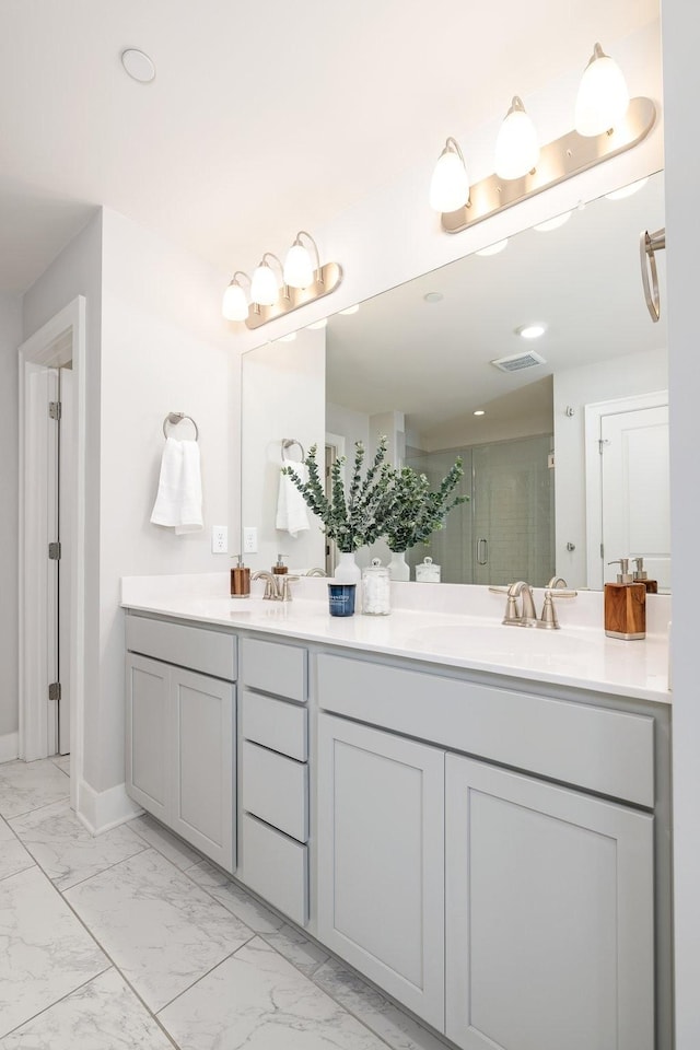 2060 Bushnell Farm Dr, Franklin, TN 37064 - bathroom with double vanity, a shower stall, marble look tiles, and baseboards
