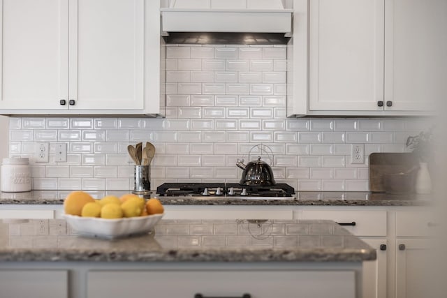2060 Bushnell Farm Dr, Franklin, TN 37064 - kitchen with tasteful backsplash, white cabinets, custom range hood, dark stone countertops, and stainless steel gas cooktop