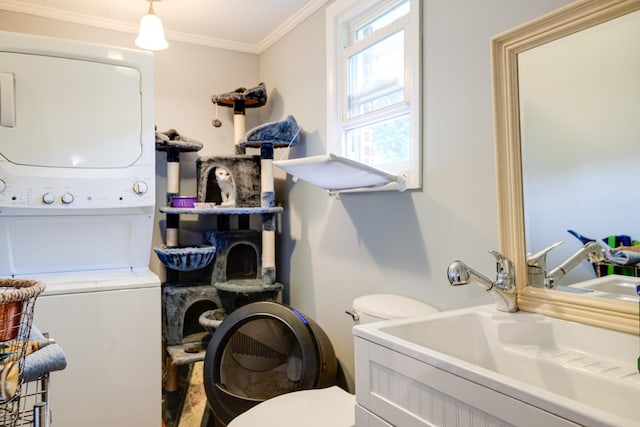 470 Arlington St, Erin, TN 37061 - laundry area featuring stacked washer / drying machine and ornamental molding