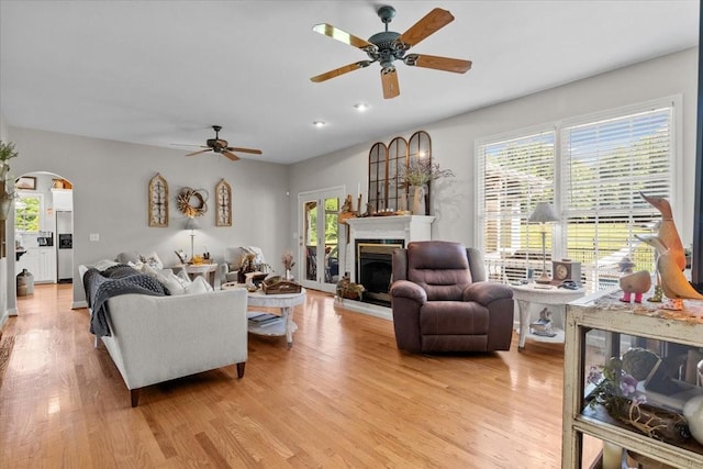 495 Baker Rd, Dickson, TN 37055 - living area featuring ceiling fan, arched walkways, light wood-type flooring, a fireplace with raised hearth, and recessed lighting