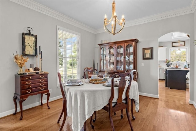 495 Baker Rd, Dickson, TN 37055 - dining space with arched walkways, a chandelier, healthy amount of natural light, light wood-style flooring, and ornamental molding