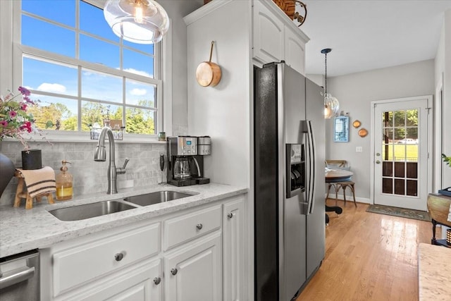 495 Baker Rd, Dickson, TN 37055 - kitchen with stainless steel fridge with ice dispenser, a sink, decorative backsplash, white cabinetry, and light wood-style flooring