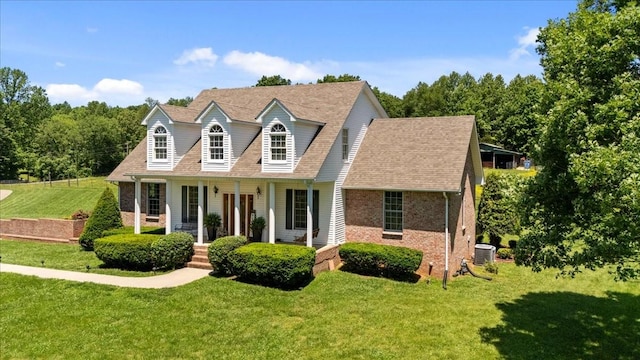 495 Baker Rd, Dickson, TN 37055 - cape cod house with a porch, brick siding, a front yard, and central AC