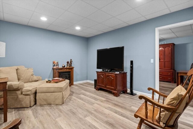 495 Baker Rd, Dickson, TN 37055 - living area with a drop ceiling, light wood-style floors, baseboards, a glass covered fireplace, and recessed lighting