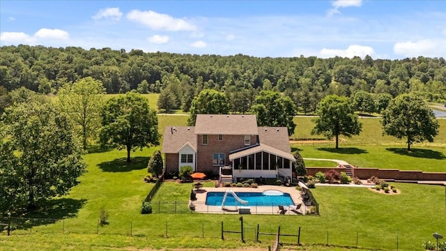 495 Baker Rd, Dickson, TN 37055 - view of swimming pool featuring a sunroom, a wooded view, and a patio area