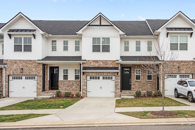1306 Halter Park Dr, Gallatin, TN 37066 - townhome / multi-family property with driveway, an attached garage, board and batten siding, and brick siding