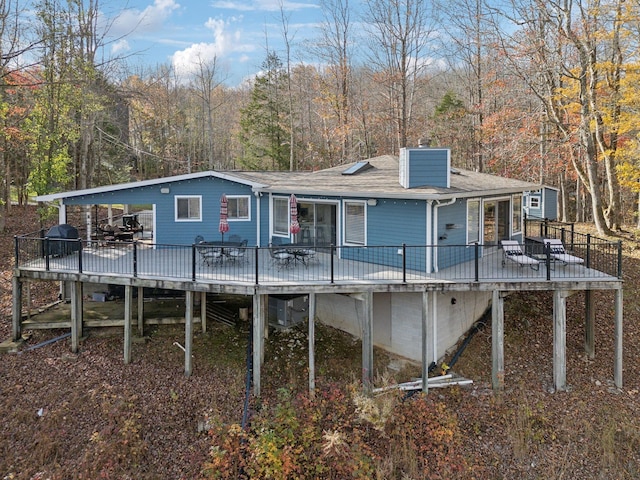 290 Spring Cir, Smithville, TN 37166 - rear view of property with a deck, a chimney, a view of trees, and a shingled roof