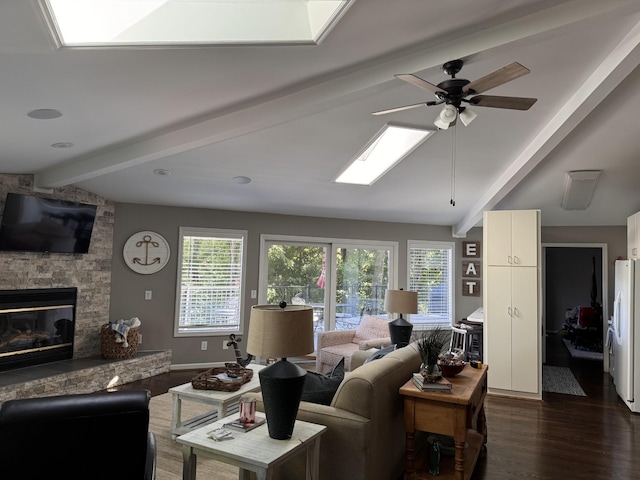 290 Spring Cir, Smithville, TN 37166 - living area featuring a fireplace, ceiling fan, a skylight, and dark wood-type flooring