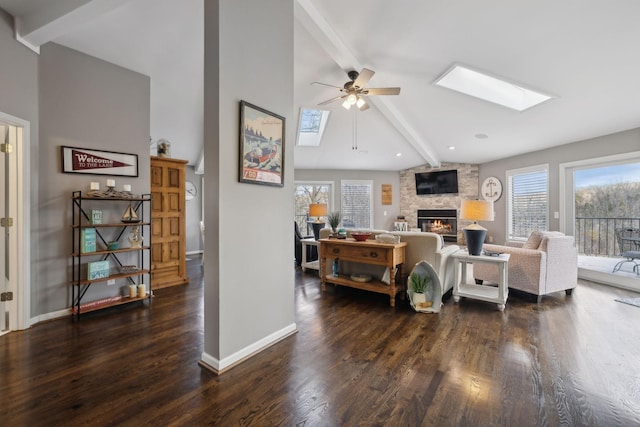 290 Spring Cir, Smithville, TN 37166 - living area featuring beam ceiling, a ceiling fan, a skylight, a fireplace, and healthy amount of natural light