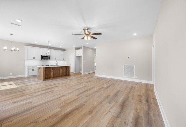 1456 Sango Commons Way, Clarksville, TN 37043 - unfurnished living room featuring a chandelier, light wood finished floors, a ceiling fan, baseboards, and recessed lighting