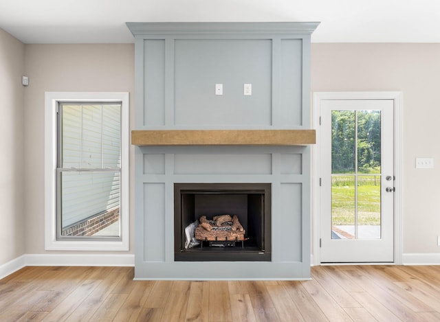 1456 Sango Commons Way, Clarksville, TN 37043 - detailed view of a large fireplace, wood finished floors, and baseboards