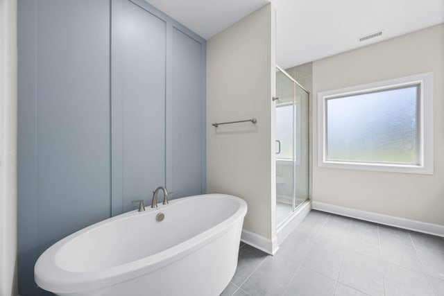 1456 Sango Commons Way, Clarksville, TN 37043 - bathroom with a stall shower, baseboards, a soaking tub, and tile patterned floors