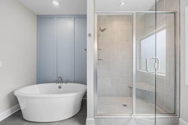 1456 Sango Commons Way, Clarksville, TN 37043 - bathroom featuring a stall shower, a freestanding bath, tile patterned flooring, baseboards, and recessed lighting