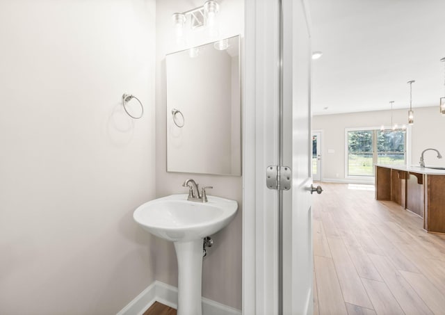 1456 Sango Commons Way, Clarksville, TN 37043 - bathroom featuring wood finished floors, baseboards, and a sink