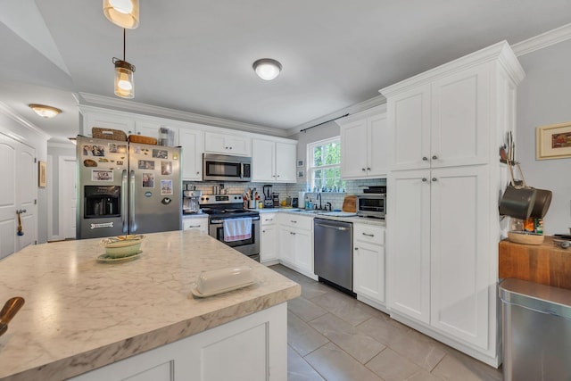 27 Lightning Bug Ln, Sewanee, TN 37375 - kitchen with stainless steel appliances, crown molding, white cabinetry, tasteful backsplash, and hanging light fixtures
