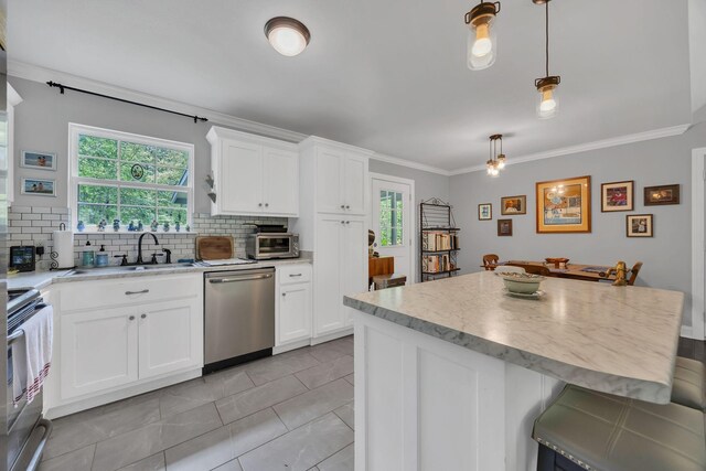 27 Lightning Bug Ln, Sewanee, TN 37375 - kitchen with appliances with stainless steel finishes, a sink, backsplash, white cabinets, and crown molding