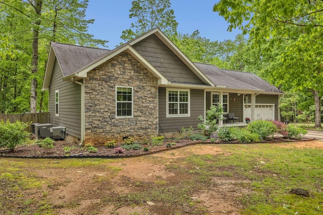 27 Lightning Bug Ln, Sewanee, TN 37375 - view of front facade featuring a garage, stone siding, driveway, and a shingled roof