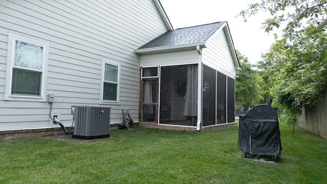 3303 Hampton Turner Dr, Murfreesboro, TN 37128 - rear view of house with central air condition unit, a sunroom, a lawn, and roof with shingles