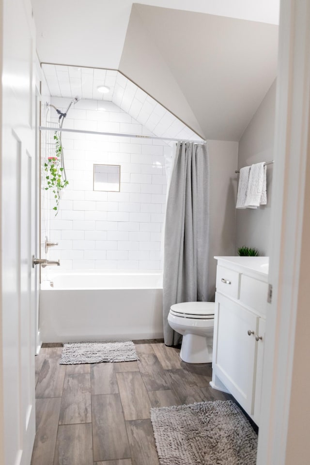 3303 Hampton Turner Dr, Murfreesboro, TN 37128 - bathroom featuring toilet, wood finished floors, shower / tub combo with curtain, vanity, and vaulted ceiling