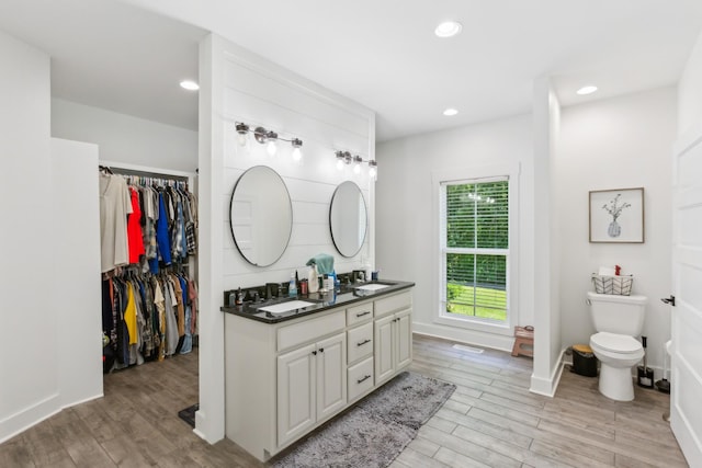 1930 Williams Rd, Lafayette, TN 37083 - bathroom with double vanity, wood finished floors, toilet, recessed lighting, and baseboards