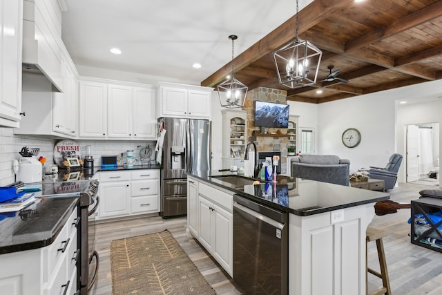 1930 Williams Rd, Lafayette, TN 37083 - kitchen with stainless steel appliances, a sink, a chandelier, dark countertops, and open floor plan