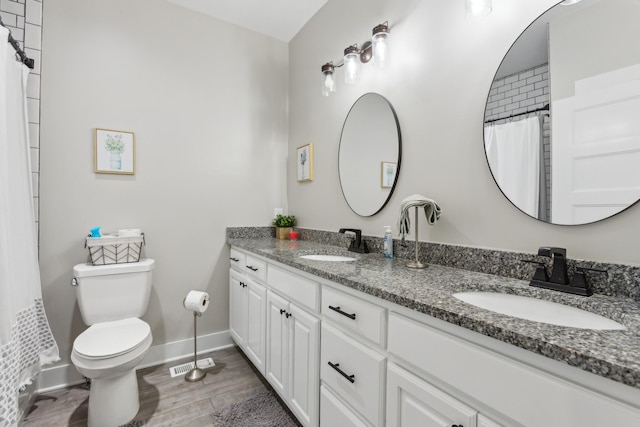 1930 Williams Rd, Lafayette, TN 37083 - full bathroom featuring double vanity, toilet, wood finished floors, baseboards, and a shower with shower curtain
