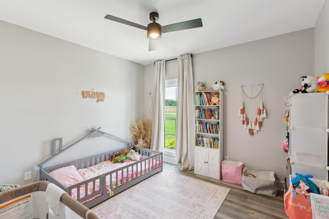 1930 Williams Rd, Lafayette, TN 37083 - bedroom featuring wood finished floors, a crib, and a ceiling fan