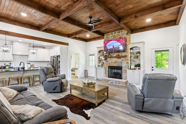 1930 Williams Rd, Lafayette, TN 37083 - living room with wood ceiling with exposed beams, light wood-type flooring, a stone fireplace, ceiling fan, and recessed lighting