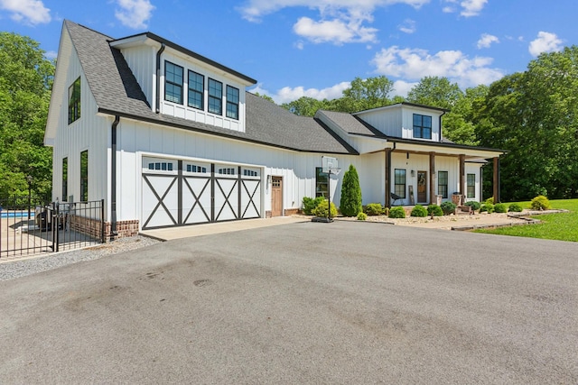 1930 Williams Rd, Lafayette, TN 37083 - modern farmhouse style home with driveway, roof with shingles, covered porch, board and batten siding, and an attached garage