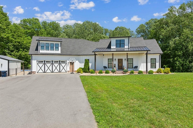 1930 Williams Rd, Lafayette, TN 37083 - modern farmhouse style home featuring board and batten siding, driveway, a garage, covered porch, and a standing seam roof