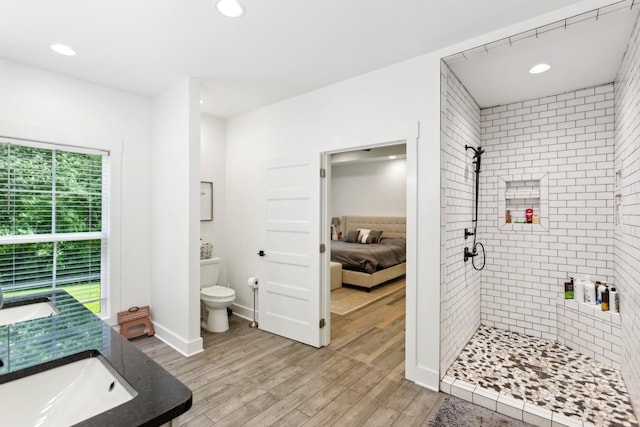1930 Williams Rd, Lafayette, TN 37083 - ensuite bathroom featuring toilet, a tile shower, recessed lighting, wood finished floors, and vanity