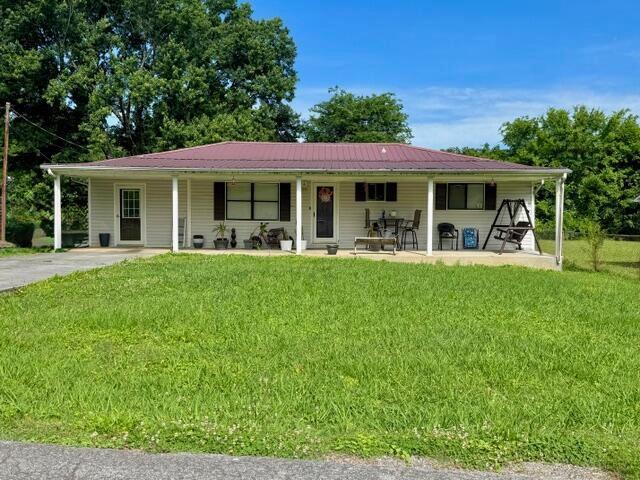 437 Yoakum St, Dayton, TN 37321 - view of front of house with a front lawn and covered porch