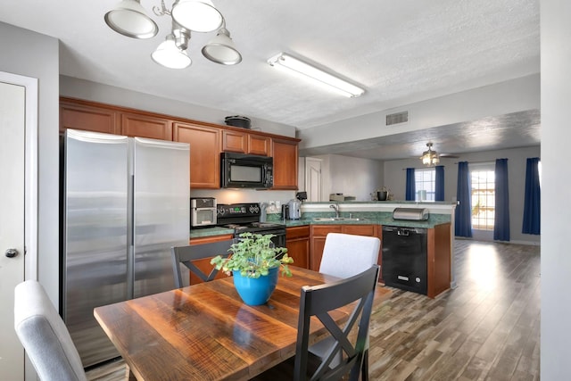 362 Shoshone Pl, Murfreesboro, TN 37128 - kitchen with black appliances, a sink, a peninsula, a chandelier, and brown cabinets