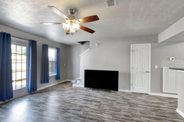 362 Shoshone Pl, Murfreesboro, TN 37128 - unfurnished living room with a textured ceiling, wood finished floors, a ceiling fan, and baseboards