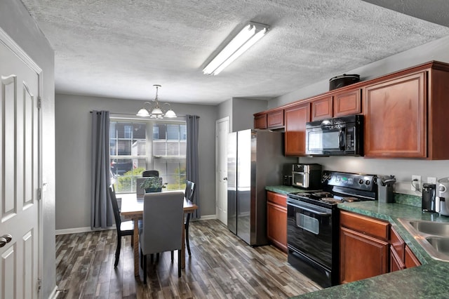 362 Shoshone Pl, Murfreesboro, TN 37128 - kitchen with black appliances, a chandelier, dark wood-type flooring, a textured ceiling, and dark countertops