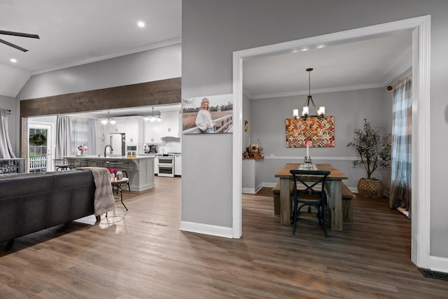 living area featuring a chandelier, crown molding, wood finished floors, ceiling fan, and recessed lighting