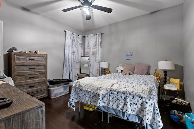 bedroom with dark wood-style floors and a ceiling fan