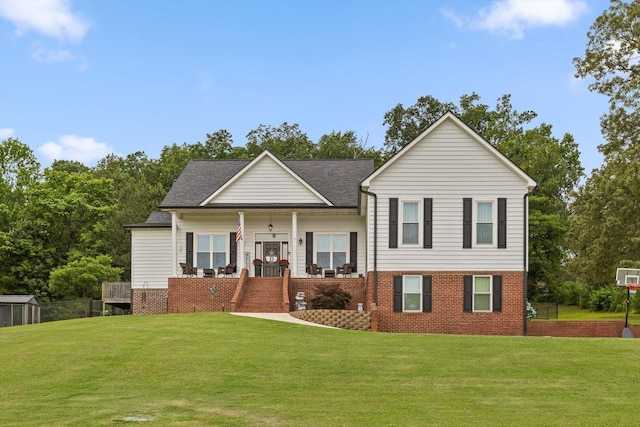 tri-level home featuring a front yard, brick siding, covered porch, and stairs